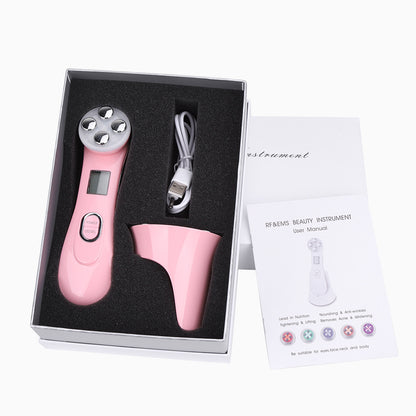 Pink beauty instrument with USB cable and user manual in a box on a white background