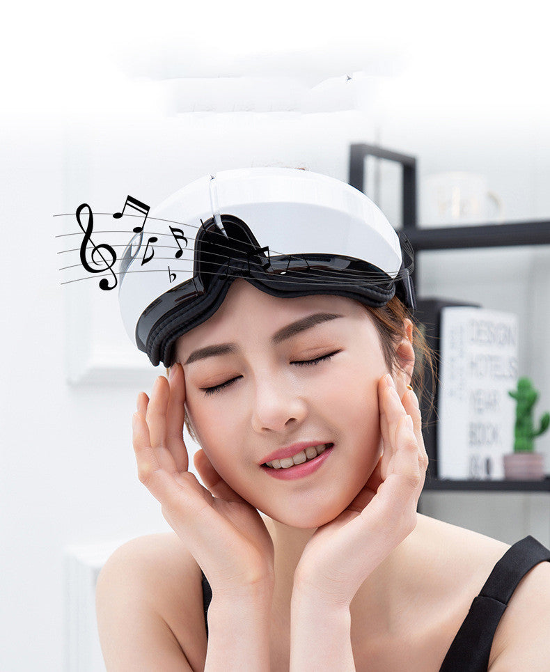 Woman wearing a white sleep mask with black bow, eyes closed, in a room setting.