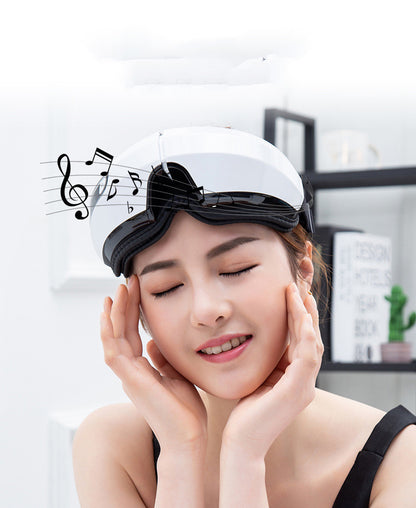 Woman wearing a white sleep mask with black bow, eyes closed, in a room setting.