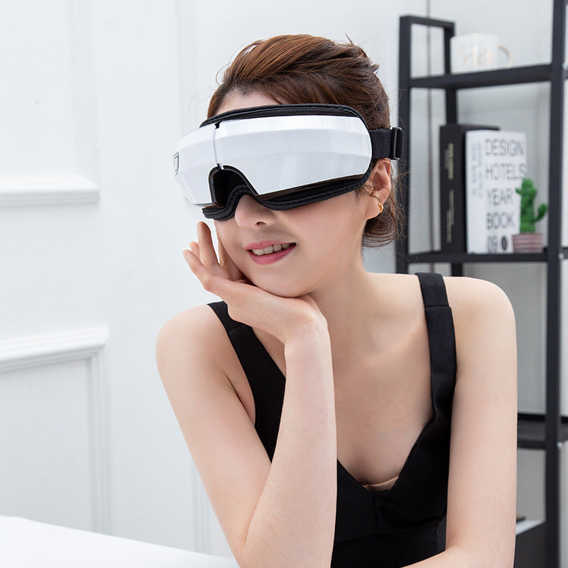 Woman wearing a white eye mask in a modern room.